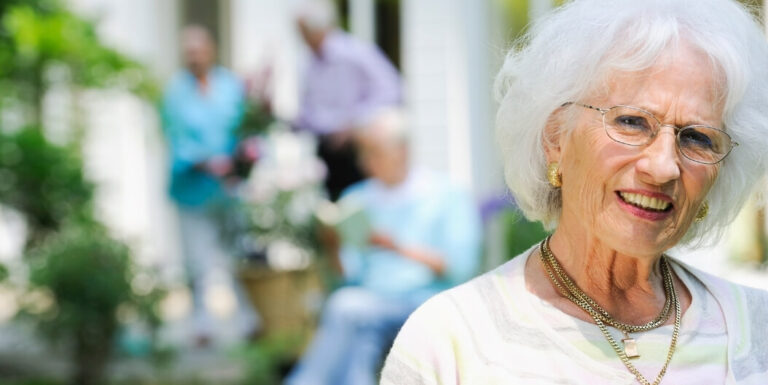 Senior Woman Smiling Outdoors at Assisted Living Facility