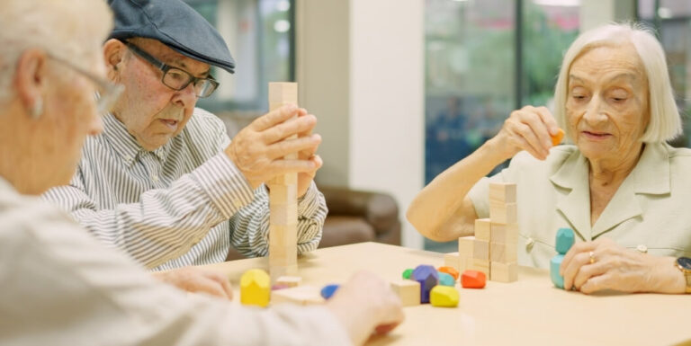 Elderly Residents Engaged in Cognitive Block Activities at a Memory Care Facility