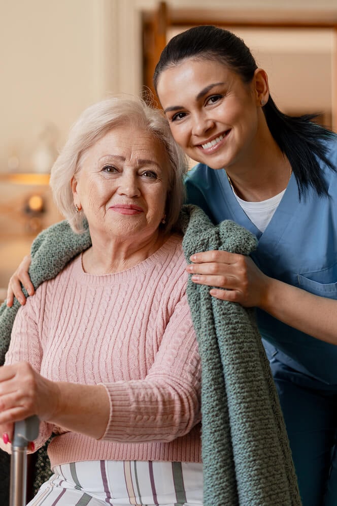 Nurse Comforting Elderly Woman at Nursing Home Colleyville